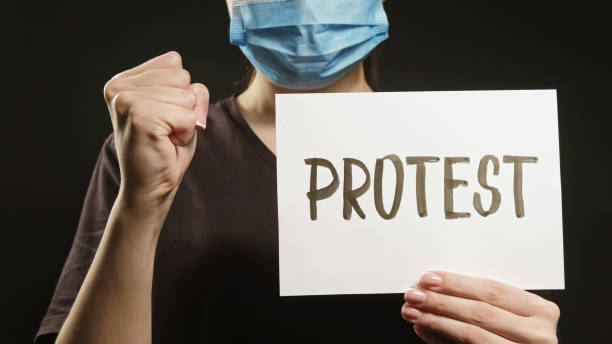 istock Ecology protest air pollution activist mask sign 1602700195