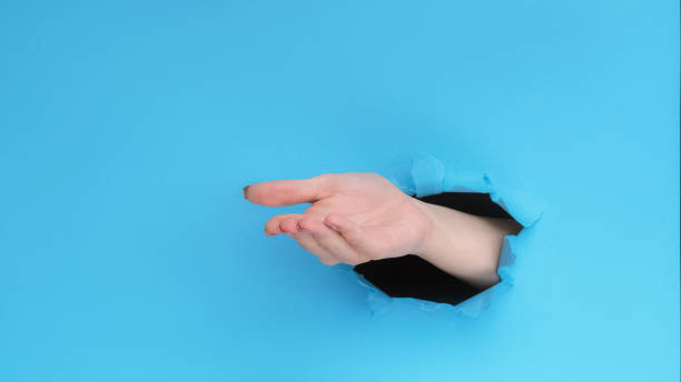 istock Give gesture pay money hand open palm ripped paper 1602700561
