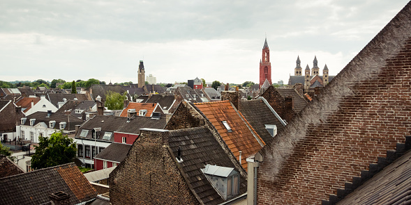 Maastricht, Netherlands - June 22 2014: Maastricht old town cityscape with tiled roofs and chimneys of old buildings