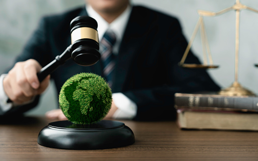 Judge hold wooden gavel with golden scale and globe for law international environmental concepts of business corporate and industry. law world environmental regulation.sustainable environment concept