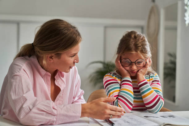 istock Distracted girl learning at home with her mother 1602720824