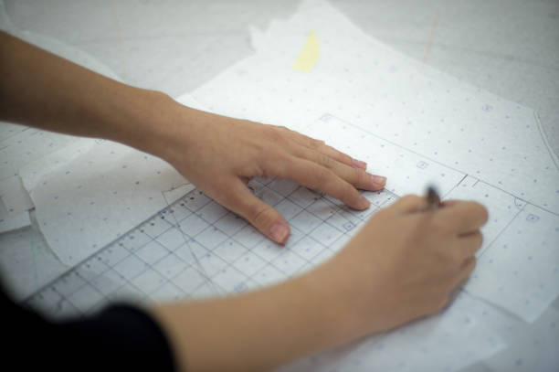 istock Concentrated  female designers  preparing pattern on fabric. 1602758176