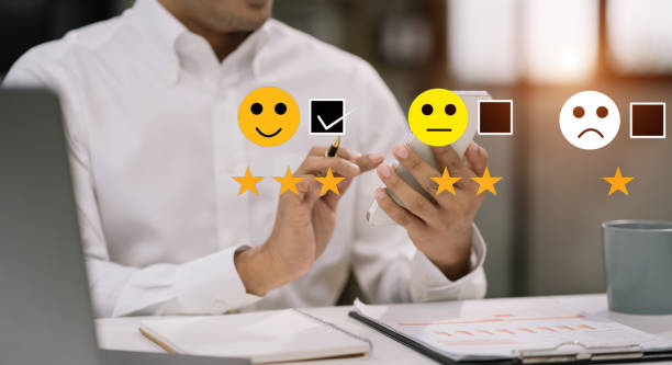 istock Male holding a digital smartphone with checkboxes rating smiley faces excellent for Satisfaction Survey, Happy Client Customer Experience concept. 1602758736
