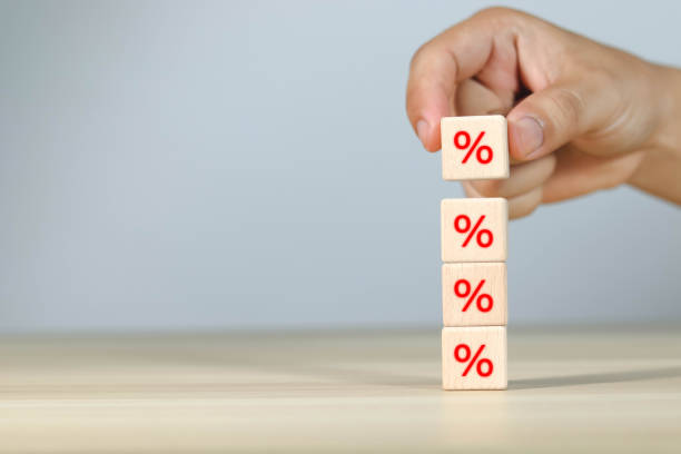 istock hand picking interest rate on wooden block 1602790156