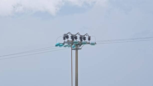 istock Overhead Medium Voltage Electric Power Lines Pole with Glass Insulators 1602796964