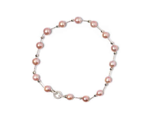istock A meticulously crafted necklace, presenting multiple lustrous pink pearls threaded together. Enhanced by a finely detailed sterling silver clasp, the elegance is undeniable. 1602809245