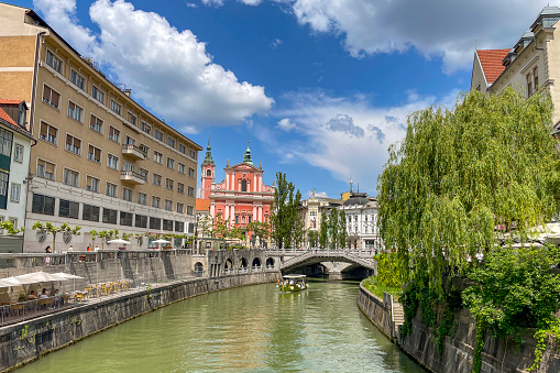 Ljubljana city view with the Ljubljanica river running through the capitol city of Slovenia during a beautiful springtime day.