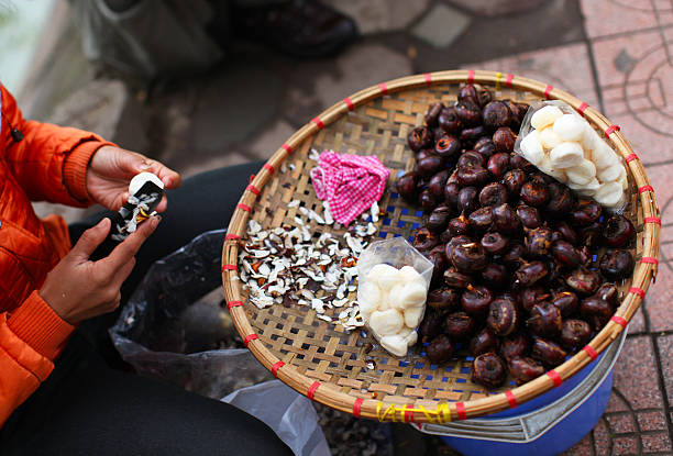 Water chestnuts being peeled at the market in Asia stock photo