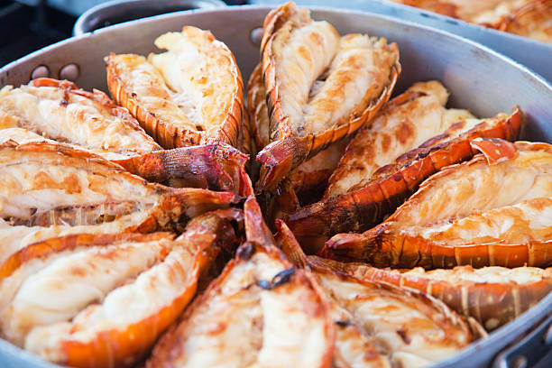 grilled lobster pieces of fresh lobster being grilled tail fin photos stock pictures, royalty-free photos & images