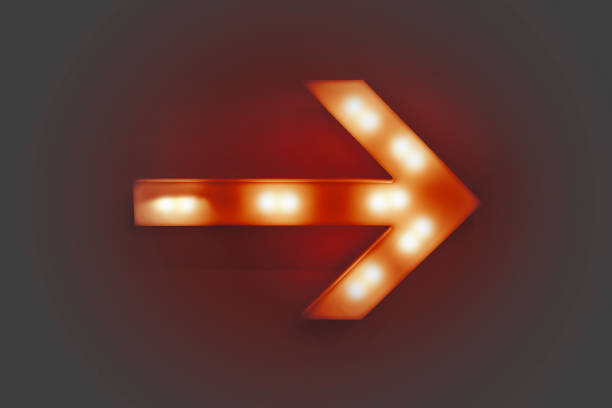 Red illuminated arrow stock photo