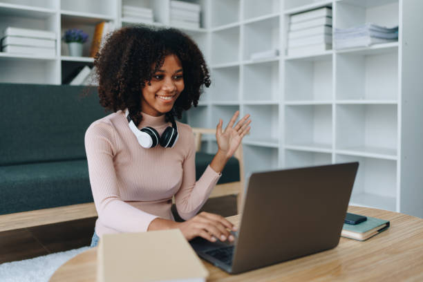 istock Video call or conference, african american university foreign exchange students study online on laptop pc english language class Exchange Program by international specialists with master at home 1602860511