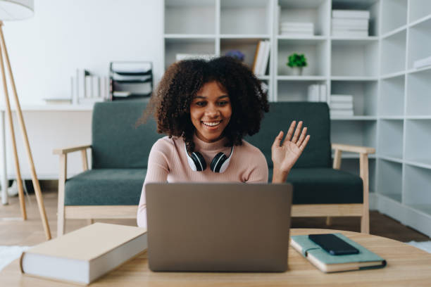 istock Video call or conference, african american university foreign exchange students study online on laptop pc english language class Exchange Program by international specialists with master at home 1602861577