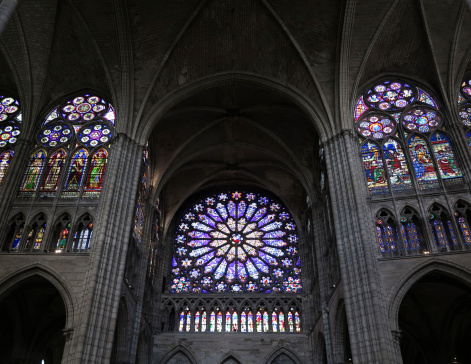 Stained glass rose window in the Basilica of St. Denis, near Paris, France. The first gothic church ever built.
