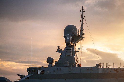 Navigation radar tower on warship at sunset close-up