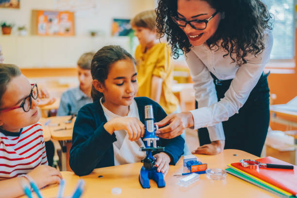 istock School children with mixed race teacher in class 1602905333