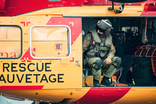 Search and rescue hitch operator sitting in a Jet Ranger CH-139 Helicopter at Collingwood Regional Airport in Canada.
