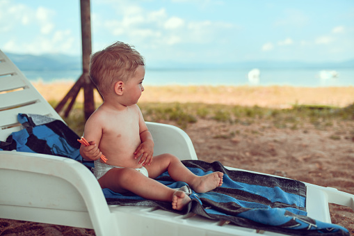 Baby Boy Enjoying Time Spent At The Beach During First Vacation