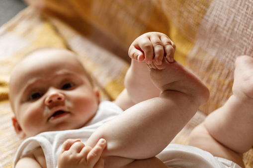 Close-up photo of newborn baby feet focused on tiny toes.