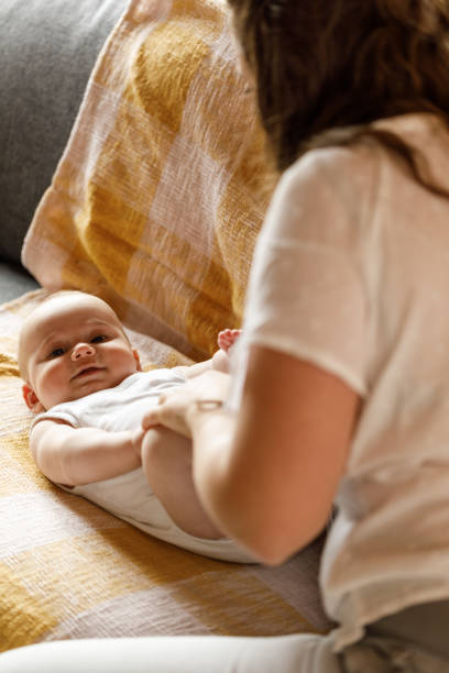 istock Baby boy playing with his feet and legs while having his diaper changed 1602914957