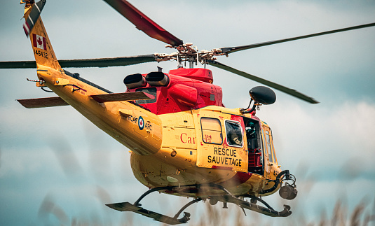 A search and rescue Jet Ranger helicopter belonging to the Canadian Air Force departs Collingwood Regional Airport in August of 2023.  Helicopter is departing to the north over using runway 13.