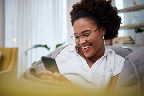 istock Laughing, meme and woman with phone on a couch using the internet, web and search on social media for joke. Online, smartphone and person relax on a sofa with mobile connection or online shopping 1602922937