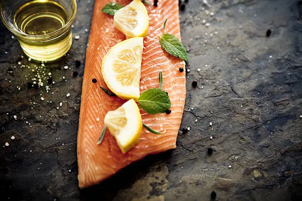 Fish and seafood: Salmon fillet, skin side down, with salt and pepper, mint lemon and lavender.