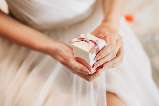 Bride holding a box with jewelry for her wedding day