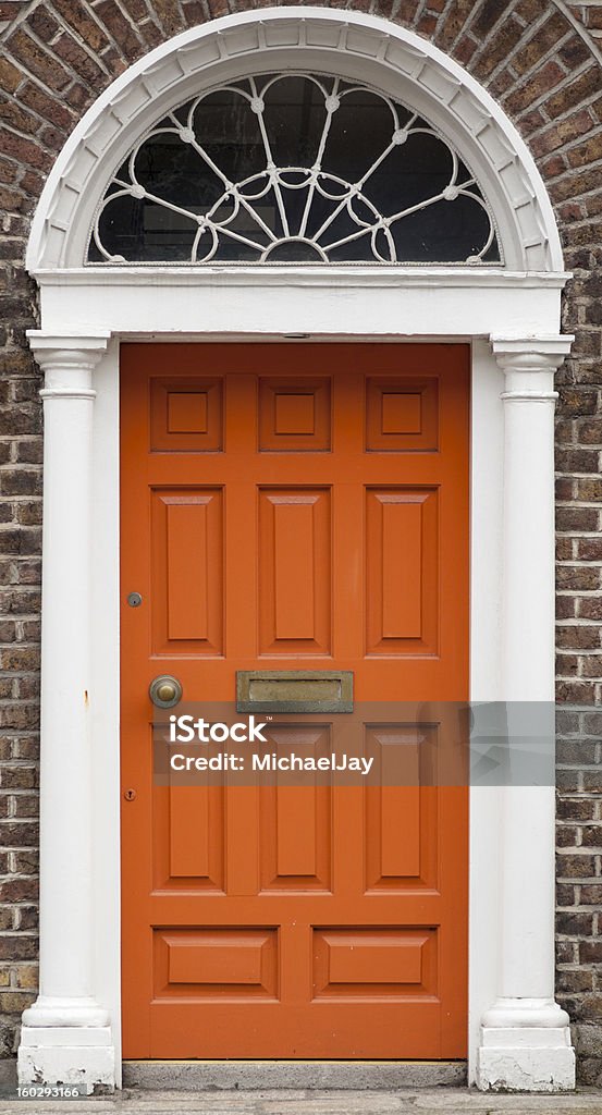 Orange colored door in Dublin from Georgian times (18th century) In the 18th century, during the Hanoverian period with British kings ruling the island, several streets and places in Dublin were redesigned. The houses at that time looked all very similar, so to differentiate the owners from their neighbours, the doors were painted in different colors and given different ornaments for their windows. Door Stock Photo