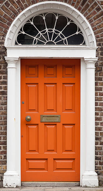 Orange colored door in Dublin from Georgian times (18th century) stock photo