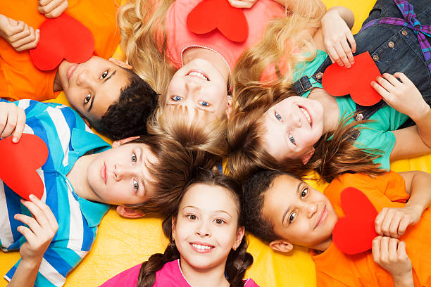istock Kids laying circle with hearts in their hands 160293431