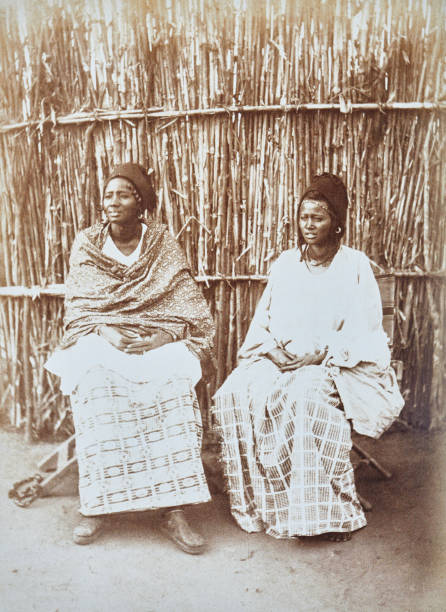 istock Niger, two women in Senoudebou sitting on a bamboo wall, 1882 1602952326