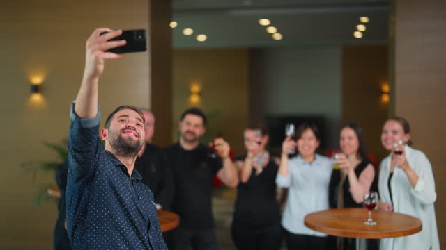Group of business people taking selfies during business party gathering