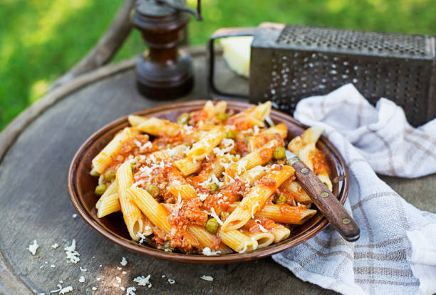 Penne pasta with bolognese sauce Penne pasta in tomato sauce with meat, bolognese sauce. Eating traditional italian food in outdoor on sunny day chicken rigatoni stock pictures, royalty-free photos & images