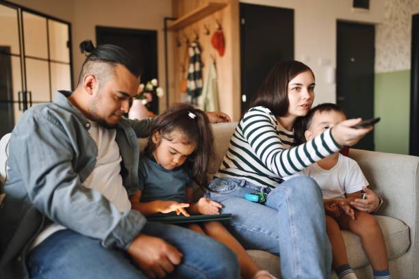 istock Beautiful family watching TV 1602973945