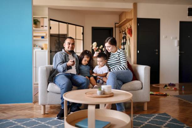 istock Modern parents watching TV with their kids 1602974602
