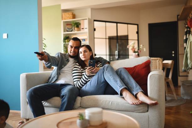 istock Lovely couple watching TV 1602976519