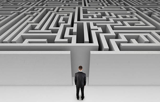 istock Man in suit about to enter a maze 160298188