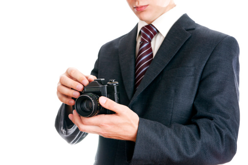 A cheerful latin business man giving two thumbs up for the camera. Isolated on a white background.