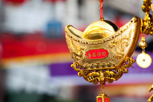 Chinese ornament representing a Chinese gold bar for wishes of prosperity as indicated with the Chinese characters Gongxi Facai