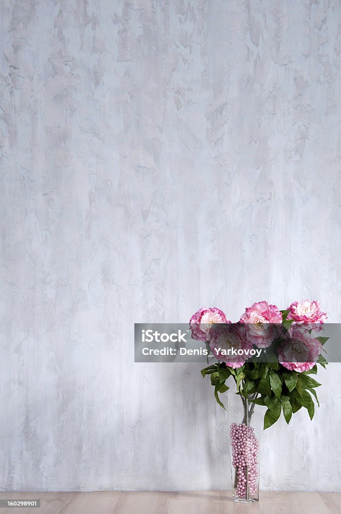 Bouquet of peonies in vase against a blue wall. Bouquet of peonies in a vase against a blue wall. Interior. Abstract Stock Photo