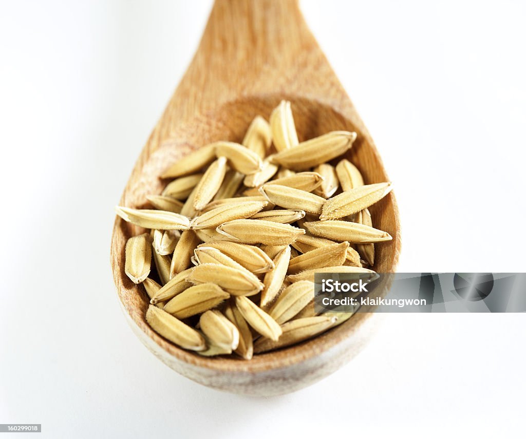 Cuchara de madera con semillas de paddy - Foto de stock de Agricultor libre de derechos