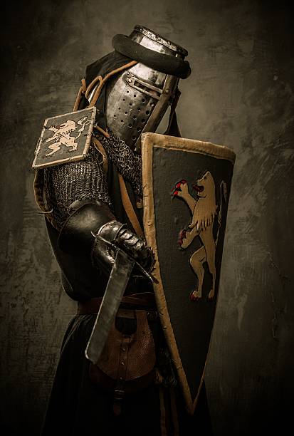 istock Medieval knight with sword and shield against stone wall 160300347