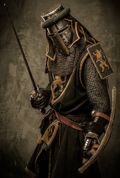 istock Medieval knight metal mesh armor sword shield posing scary 160300377
