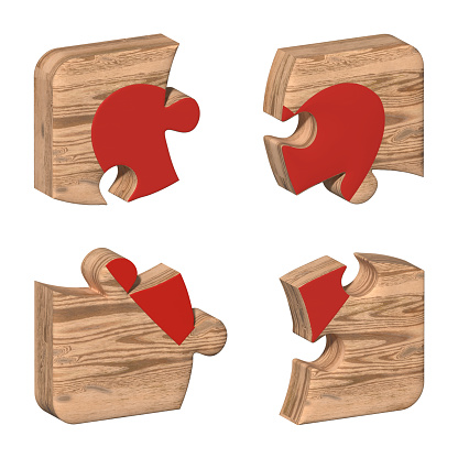 Wooden puzzles with a red heart pattern. Pieces of a wooden mechanical puzzle are connected. Heart for Valentine's Day. Symbol of love. The 14th of February.