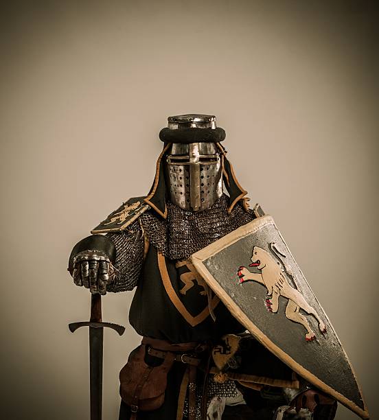 istock Kneeled medieval knight with sword and shield 160300446