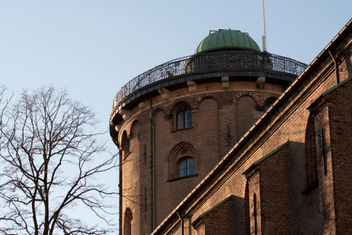 The top of the Round Tower (Rundetårn in Danish) illuminated by the setting winter sun.
