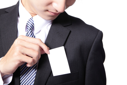 Close up of business card in business man suit pocket (great for copy space) - horizontal , asian male model