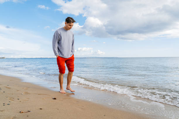 istock Young Man Walking On The Beach In Greece 1603026626