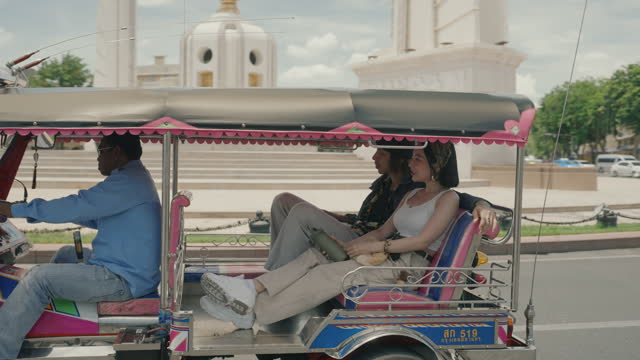Cultural Journey: Young Travelers Enjoying Bangkok's Local Taxi Tour.