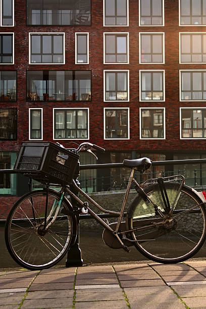 istock Bicycle with basket resting over a canal fence 160303541